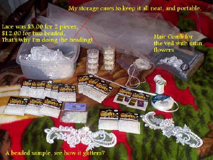  Picture of small bags of pearl and glass beads, clear sequins, pieces of lace, white ribbon, veil material and flower head piece, thread and needles and the assorted containers for the items and one big tupperware to store it all. (183575 bytes)