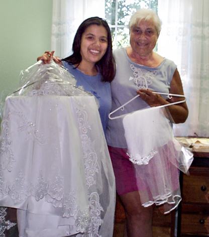 Elysia posing with her dressmaker at her home office.