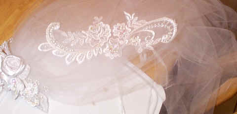 A completed hand beaded piece of lace placed on the veil. (124178 bytes)